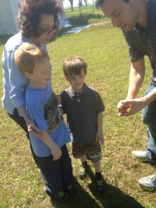Showing the boys where pecans come from.